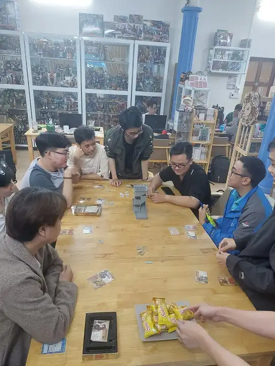 Group of friends playing board game at the shop