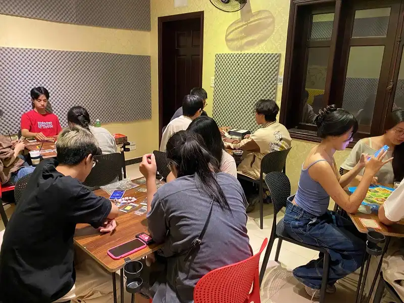 Space full of board game players in the shop