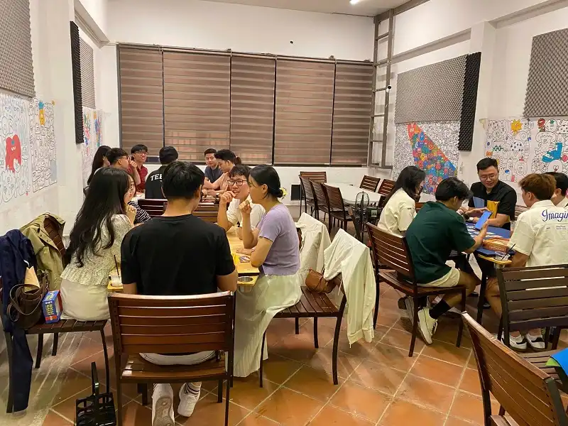 Space full of board game players in the shop